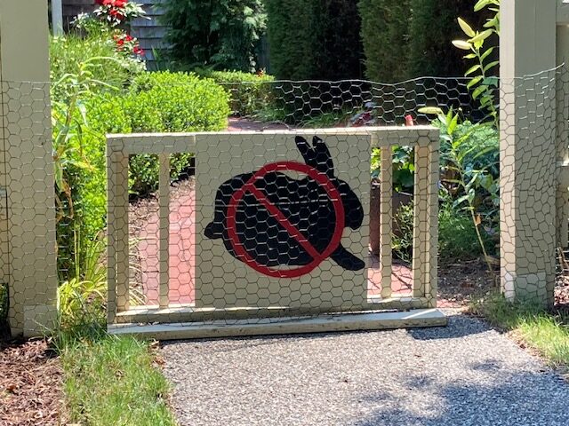 fence with painted rabbit sign